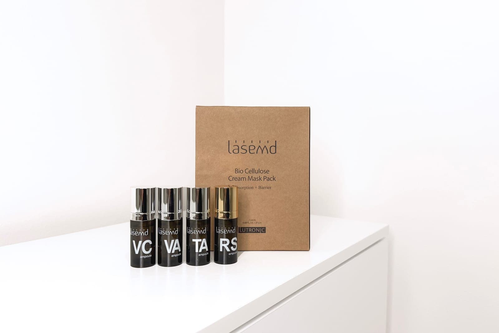 LaseMD VC, VA, TA and RS ampoules beside a box of LaseMD bio-cellulose cream masks