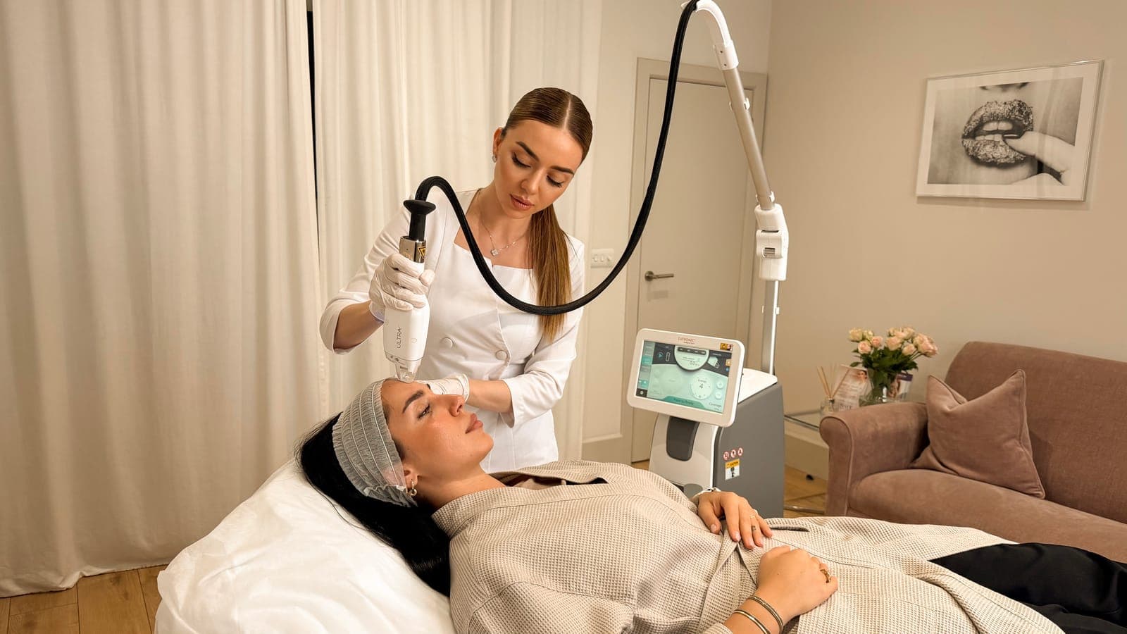 LaseMD Ultra appointment in the treatment room at ART FACE London, with the laser console beside the bed