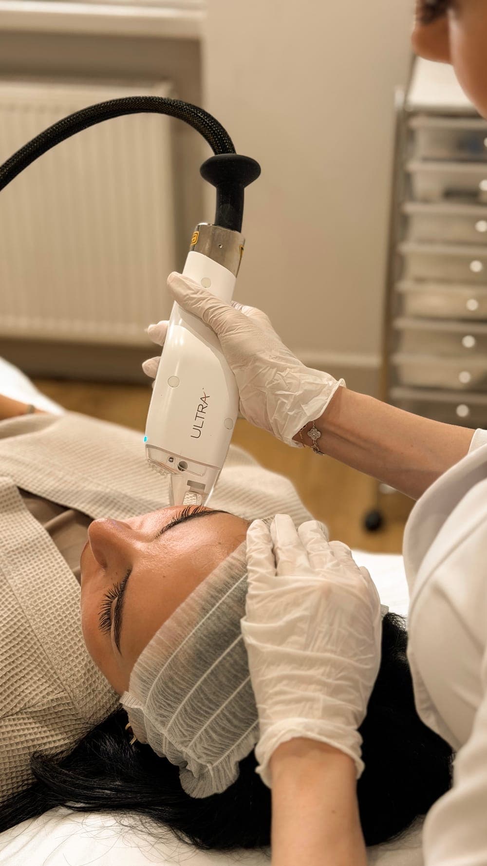 Close view of the LaseMD Ultra handpiece being moved across a client's cheek