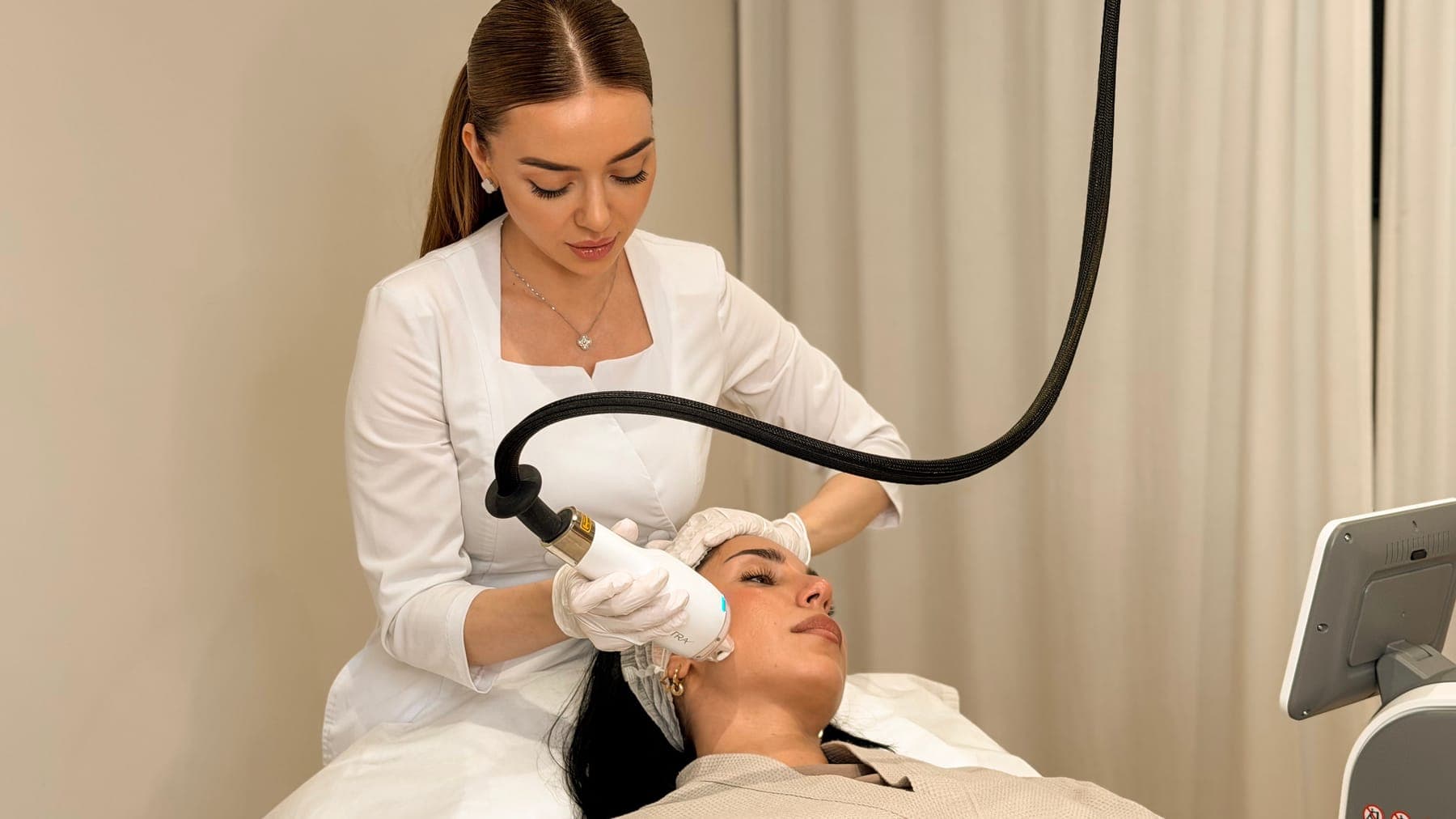 Practitioner treating a client's face with the LaseMD Ultra thulium laser at ART FACE London, Pimlico