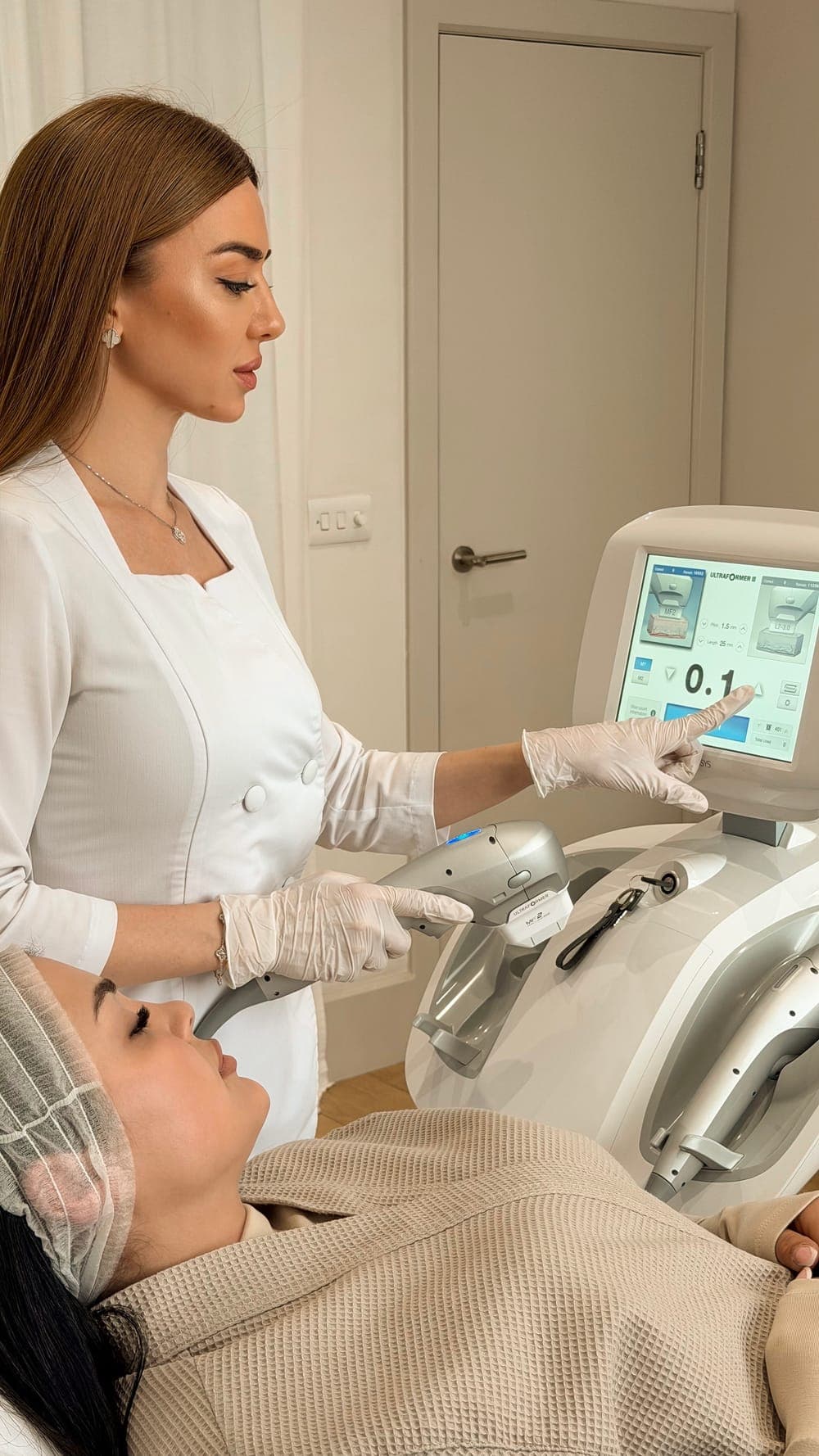Practitioner adjusting the Ultraformer III device screen before treatment at ART FACE London